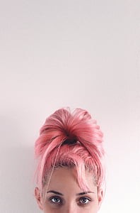 woman in pink hair beside white wall thumbnail