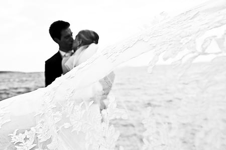 man and woman kissing in grayscale photography thumbnail
