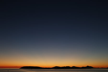 silhouette photography of island during golden hour thumbnail