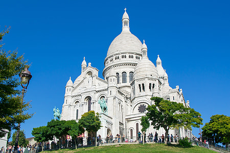 people gathered in front of white dome church thumbnail
