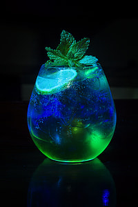 clear drinking glass with slice of lemon and green herb in close-up photography thumbnail
