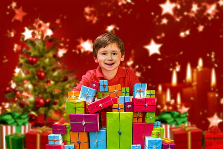 boy standing in front of gift boxes thumbnail