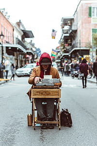 man sitting on chair with typewriter in the middle of the road thumbnail