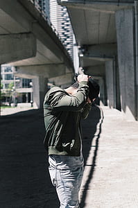 person fixing his black cap thumbnail