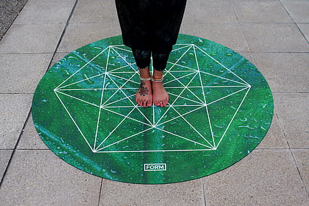 Person Standing on Green Round Mat thumbnail