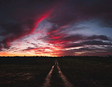grass field under cloudy sky thumbnail