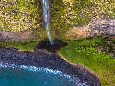 high-angle photograph of water falls near sea thumbnail