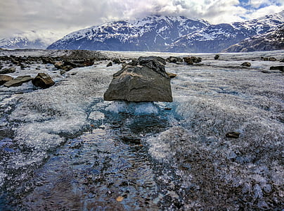 melted snow mountain with flowing water near stone thumbnail