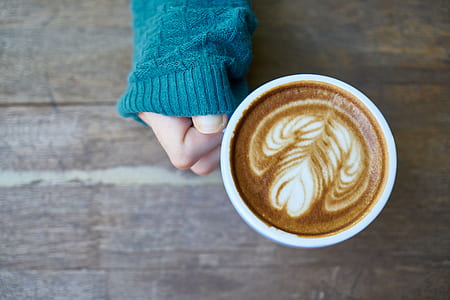 person holding cup of cappuccino thumbnail