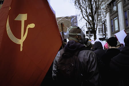 man carrying Soviet Union flag during daytime thumbnail