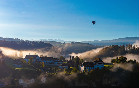 hot air balloon under clear blue sky during daytime thumbnail