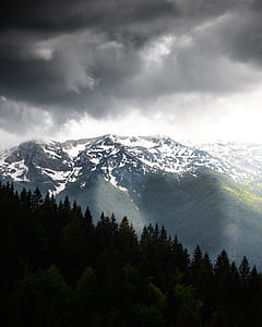 snow coated mountain during daytime thumbnail