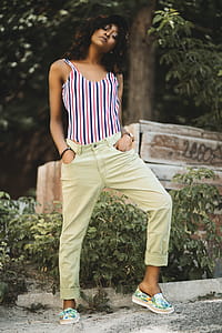 Woman in White and Black Stripe Spaghetti Strap Top and Beige Pants thumbnail