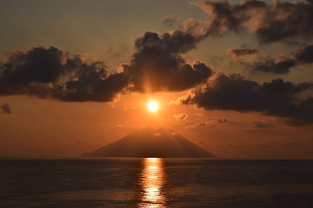 in distant photo of mountain during golden hour thumbnail