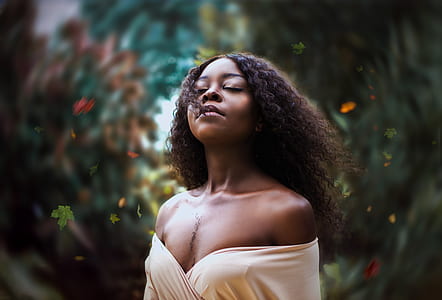 woman standing near green plants thumbnail