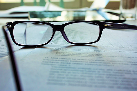 eyeglasses on top of white printer papers thumbnail
