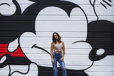 woman standing in front of Mickey Mouse printed wall thumbnail
