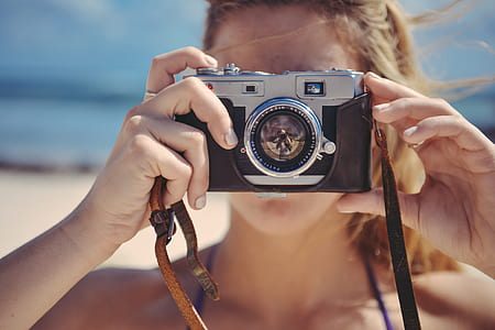 woman holding camera thumbnail