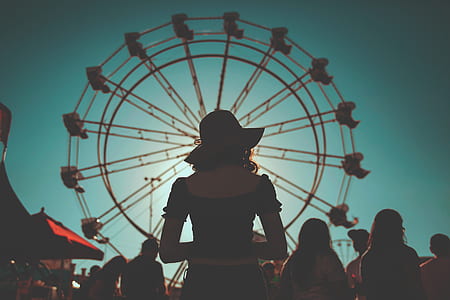photography of woman facing ferris wheel thumbnail