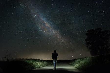 man walking on pathway during nighttime thumbnail