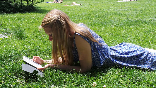 woman in blue floral sleeveless dress lying on grass thumbnail