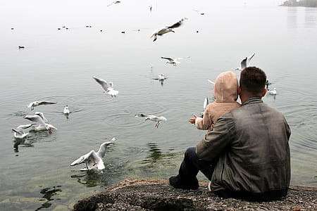 man carrying baby thumbnail
