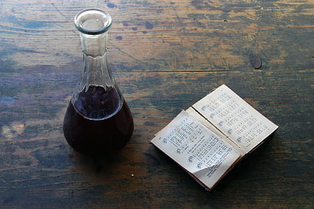 clear glass jar filled with brown liquid and brown book page thumbnail