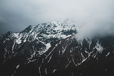 snow covered mountain surrounded by fogs thumbnail