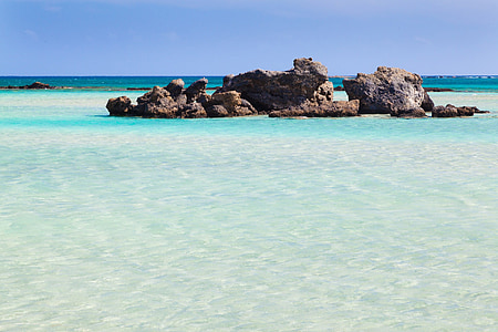 gray rocks in between body of water at daytime thumbnail