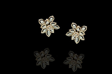 pair of gold-colored floral stud earrings thumbnail
