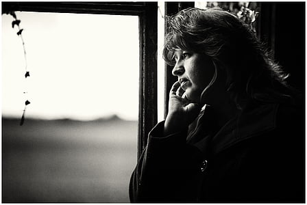 grayscale photo of a woman looking at the window thumbnail