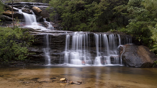 waterfalls surrounded tall trees digital wallpaper thumbnail