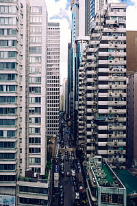 vehicles on street between high rise buildings thumbnail