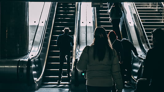 people walking towards escalator thumbnail