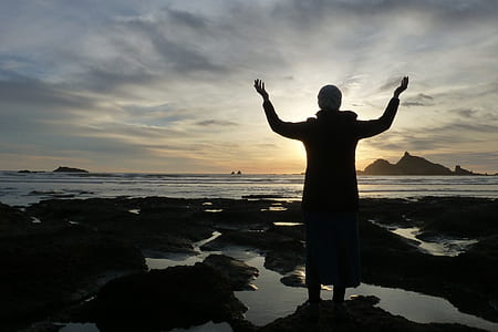silhouette photo of person rising his hands thumbnail