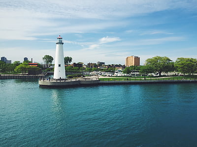 white lighthouse near body of water thumbnail