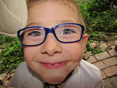 toddler in eyeglasses with blue frames thumbnail