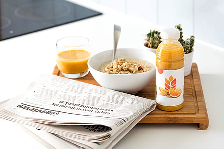newspaper beside white ceramic bowl thumbnail