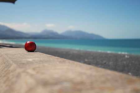 red apple fruit on top of gray stone thumbnail