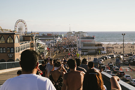 people walking toward the beach during daytime thumbnail