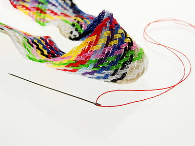 green and yellow thread and needle thumbnail