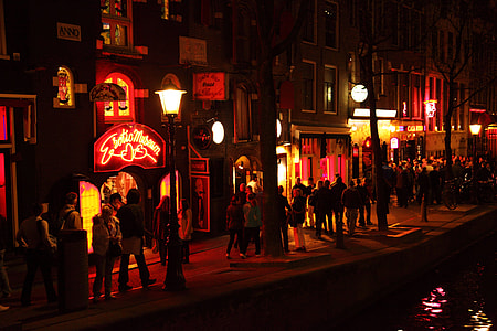 group of people walking beside lighted buildings thumbnail