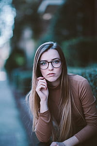 woman wearing brown knit long-sleeved and black framed eyeglasses thumbnail