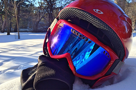 closeup photo of helmet with goggles on snow thumbnail