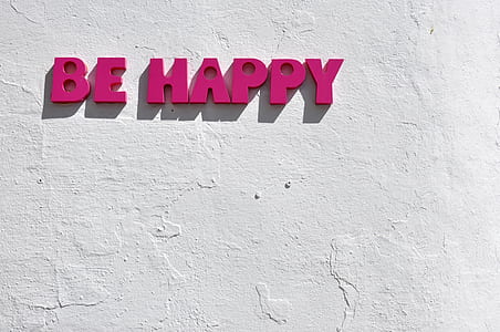 Be happy letter cutout mounted on white wall thumbnail