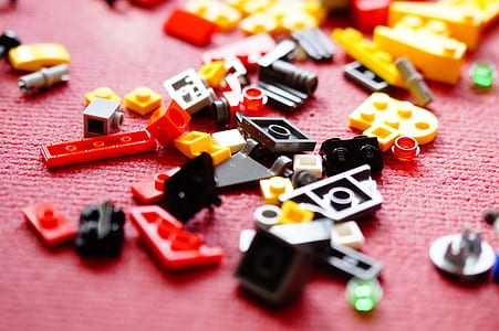selective focus photography of assorted-color building block pieces on pink linen thumbnail