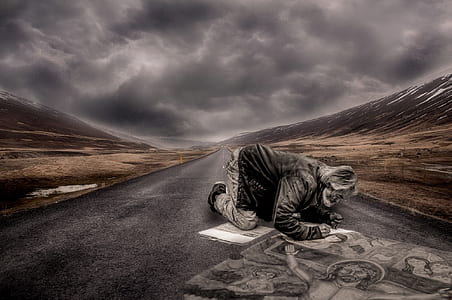 man kneeling on road artwork thumbnail