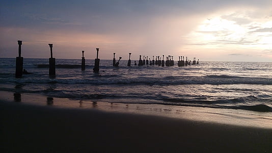 silhouette photo of post on body of water thumbnail