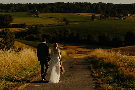 couple walking on a concrete road photo thumbnail