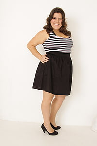 smiling woman in black and white striped sleeveless mini dress thumbnail
